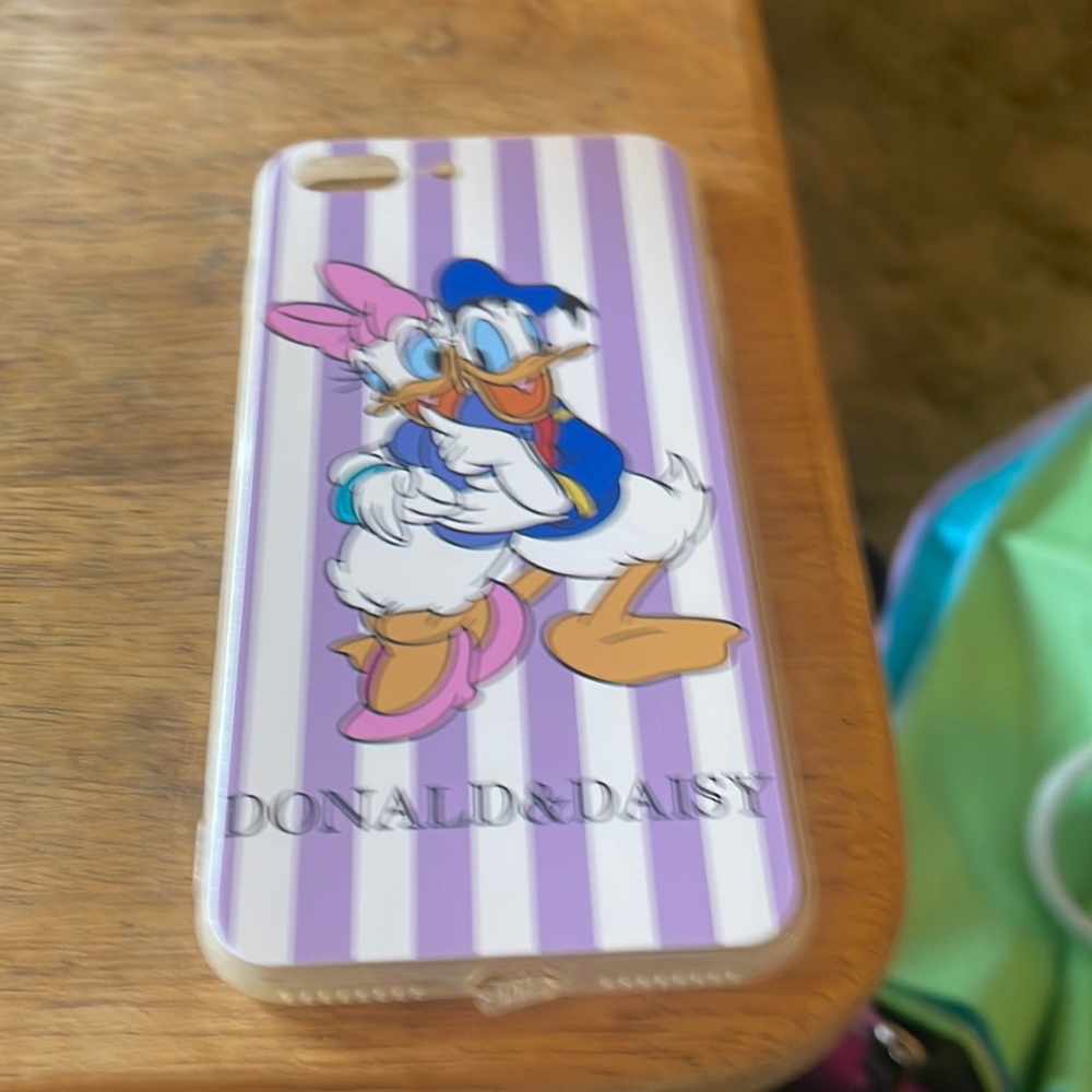 Donald and daisy striped purple iPhone 7 Plus case. Ring is removable on back.